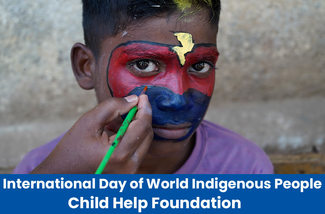  A child painting a boy’s face using traditional tribal painting patterns