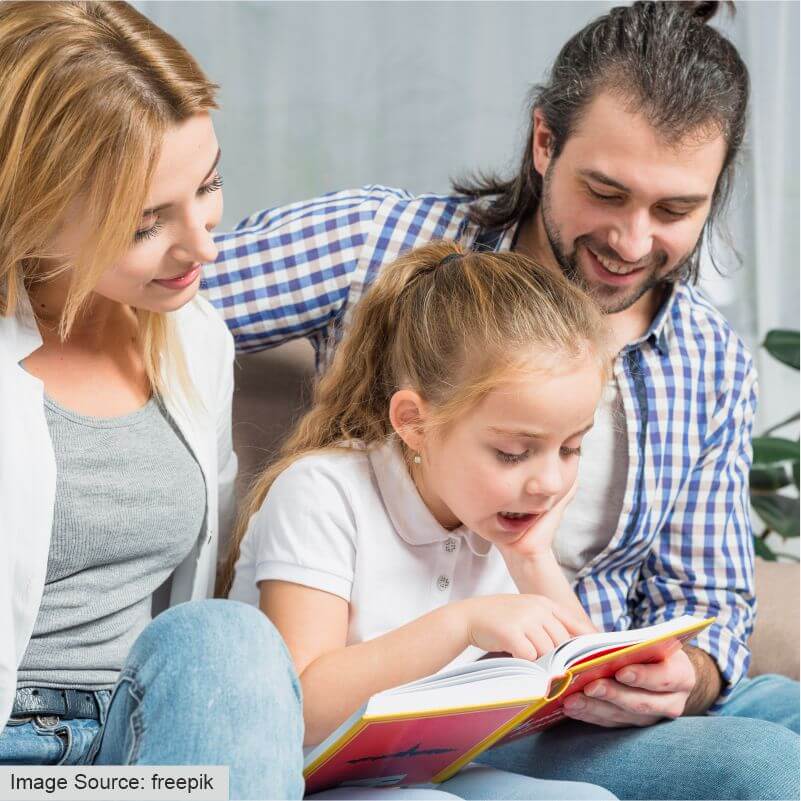 parents helping the child to read books