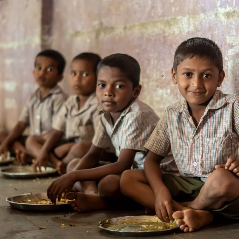 A group of children eating food together